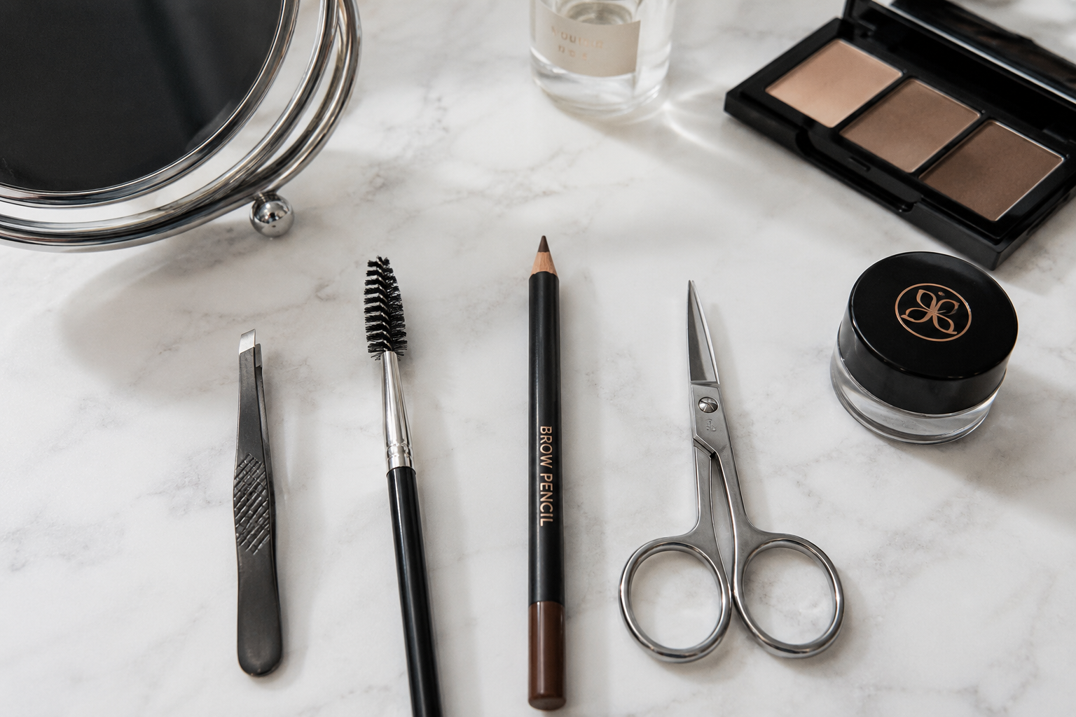 Essential eyebrow grooming tools for maintaining beautiful brows at home.